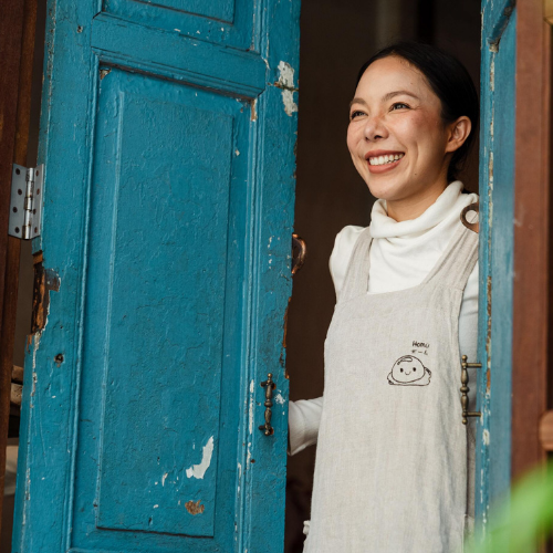 Woman opening a blue door
